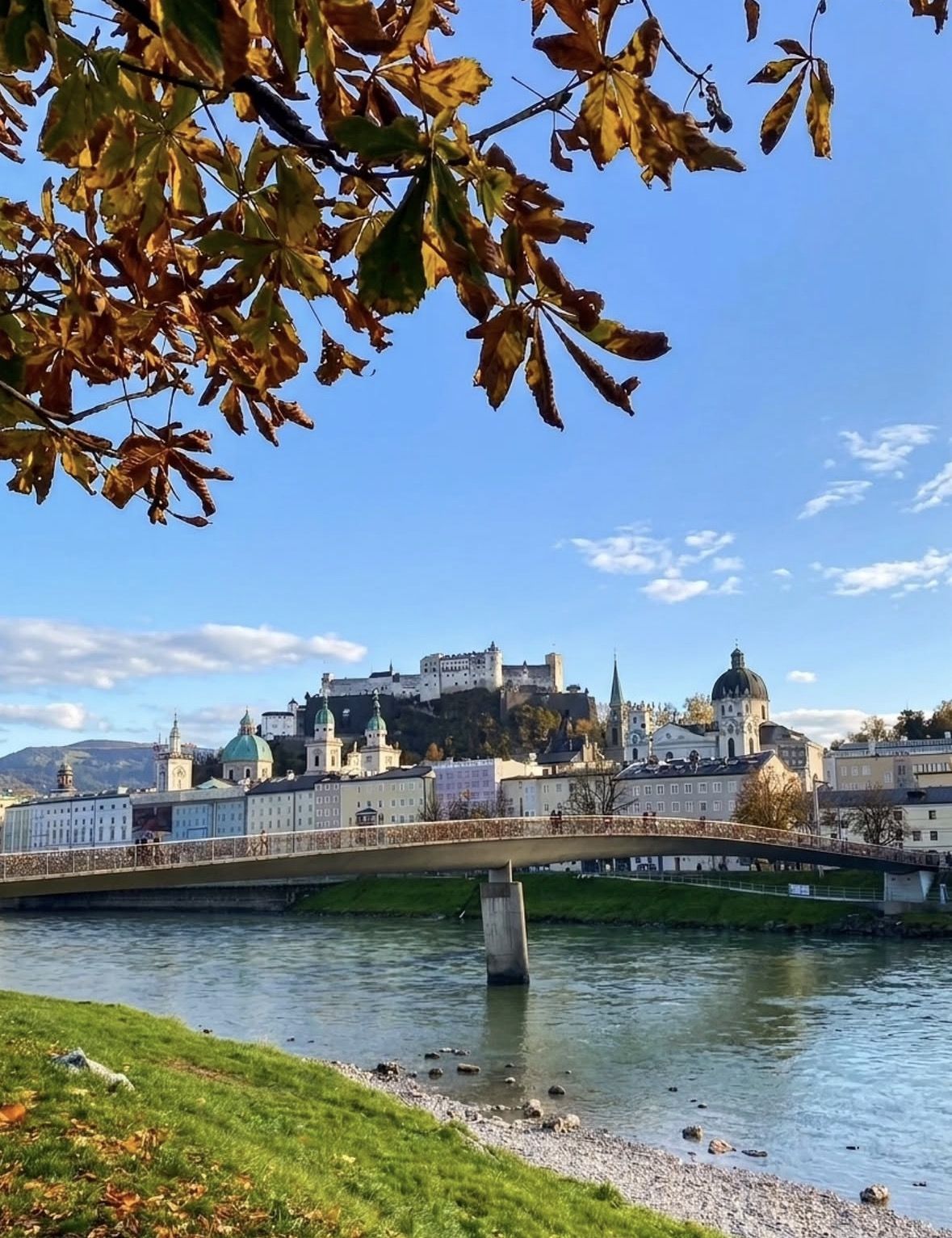 Mirabell Gardens in spring bloom with Hohensalzburg Fortress in the background